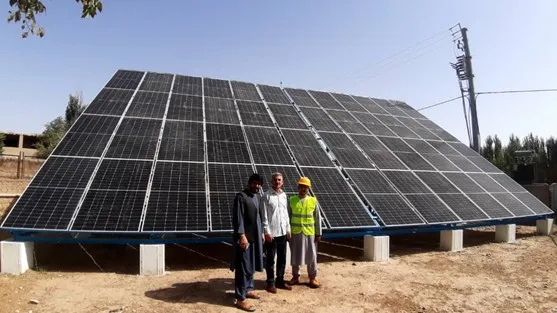 Officials at the site of the installed solar panels for well no. 2 of Maimana's water supply system.