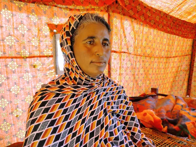 Khaldia sits inside her tent, recalling her past and contemplating the uncertain future that lies ahead. Photo: Ahmed Omer