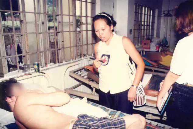Mariegen checks on an ailing person deprived of liberty. Lorenzo ARADA/ICRC Mariegen checks on an ailing person deprived of liberty.