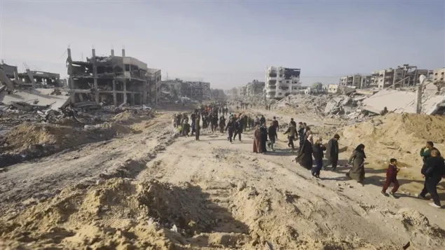 People walking along a dusty road