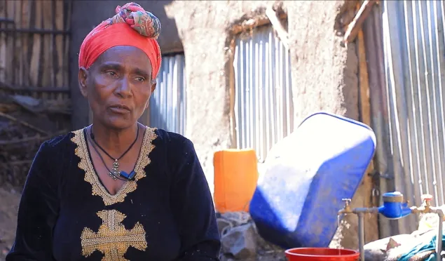 Resident of Lalibela town fetching water from the tap water in her compound.