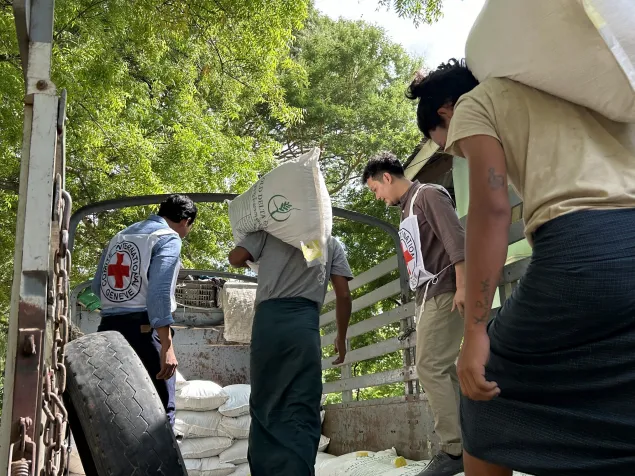 ICRC staff oversees the distribution of agricultural supplies in Myanmar.