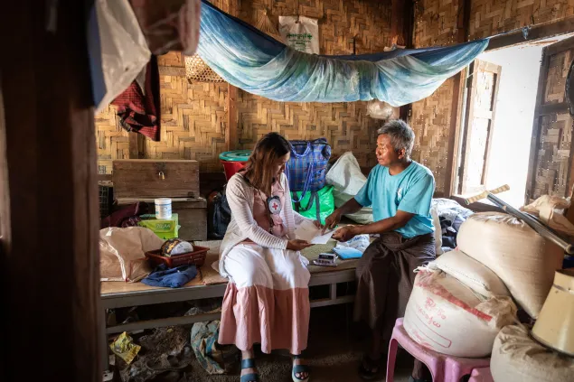 An ICRC worker with a man in Myanmar