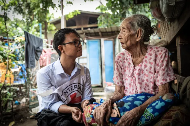 An ICRC worker with an elderly woman in Myanmar