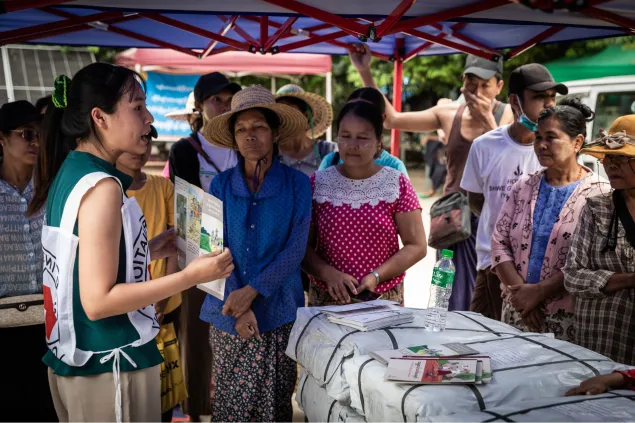 An ICRC worker speaking with community members in Myanmar