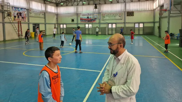 Futsal supervisor Shukrullah Zeerak coaching a player in Kabul.