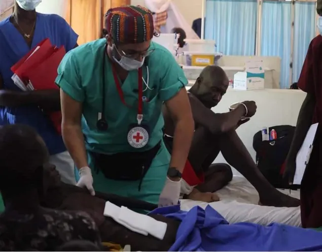 Dr. Aktham Al-Farnawani among patients.