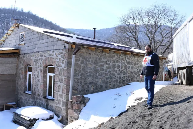 Inspecting a repaired roof in Shurnukh, which was part of the ICRC’s efforts to improve living conditions.