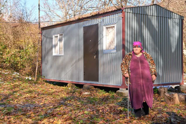 Raya (60) in front of the trailer installed by the ICRC 