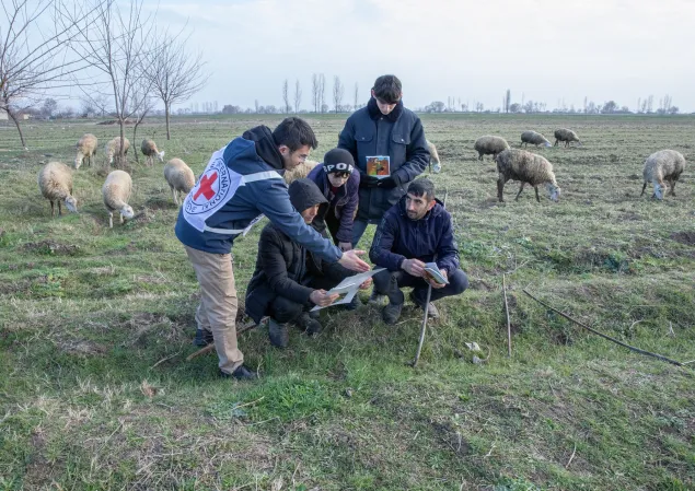 Tartar, 2024. ICRC staff members informing residents about the risks of explosive remnants of war