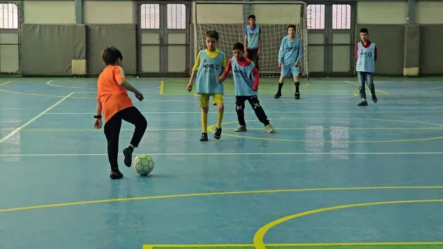 Children playing futsal inside a gymnasium at the ICRC’s physical rehabilitation centre in Kabul.