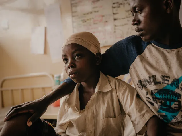 Grace, a 10 year old boy who was shot in the head (by M23 rebels), is cared for after surgery by his brother James.