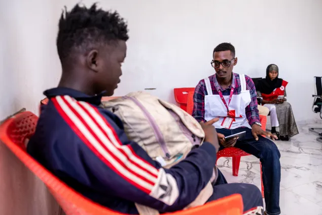 Oumar Ismaïl Zakaria, 31, a volunteer of the Red Cross of Chad, registers a Sudanese refugee at the one-stop shop on the border with Sudan, in Tiné, Chad.
