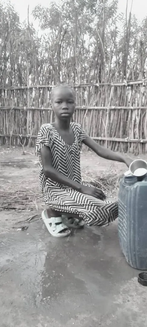Young Nyamal fetching water at the well, part of daily life for little girls at a refugee camp, Gambella region. 