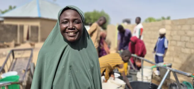 Hauwa Adamu at a water point rehabilitated by the ICRC in her community - Gavizga