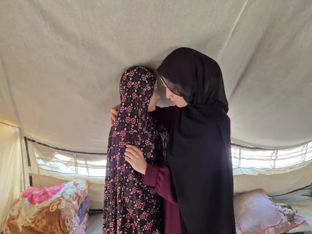 Lina Al Kurdi, 34, comforts her sister, Reem, 30, in their worn-out tent, hoping that their conditions will improve one day. Their greatest wish is to go back home. 