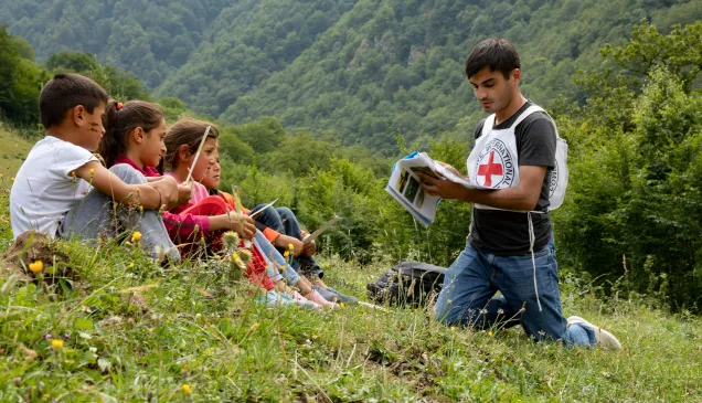 An ICRC staff member raising awareness on the dangers of mines and explosive remnants of war in the Dashkasan district, Azerbaijan.