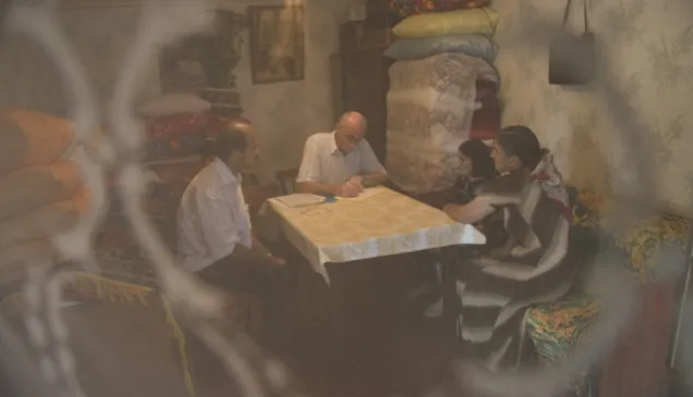 An ICRC employee is seen meeting with the family of a missing person to collect detailed antemortem data