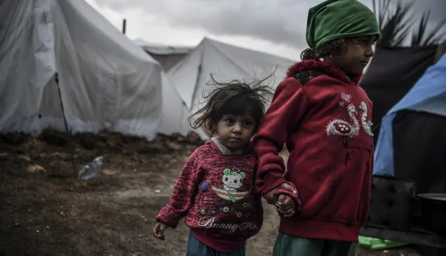 Gaza, Khan Yunis. Two sisters wander through a makeshift camp amidst the rubble of the city. They had to flee their home because of the conflict escalation.
