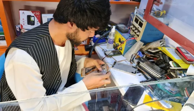Baqir repairs a smartphone in his workshop in Mazar-i-Sharif Baqir repairs a smartphone in his workshop in Mazar-i-Sharif