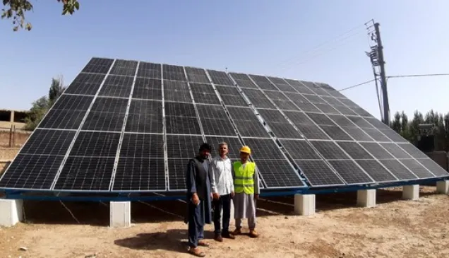 Officials at the site of the installed solar panels for well no. 2 of Maimana's water supply system.