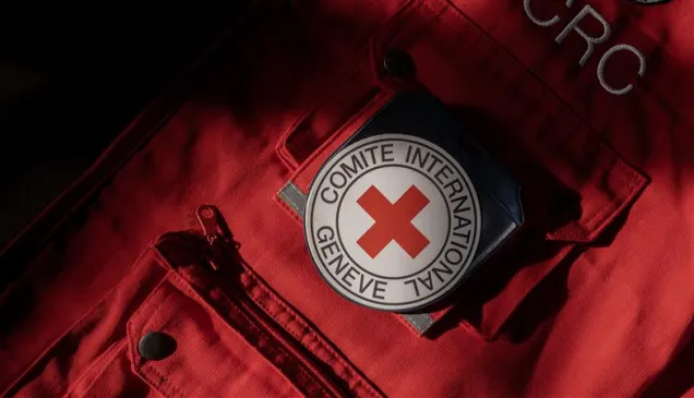 Close-up of red ICRC vest with ICRC emblem on the pocket
