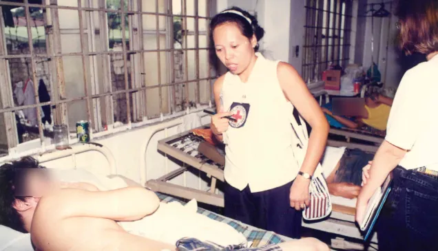 Mariegen checks on an ailing person deprived of liberty. Lorenzo ARADA/ICRC Mariegen checks on an ailing person deprived of liberty.