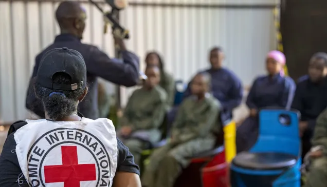 Law Students from a Kenyan University listen to an firearms instructer during an IHL War simulation in Nairobi, Kenya