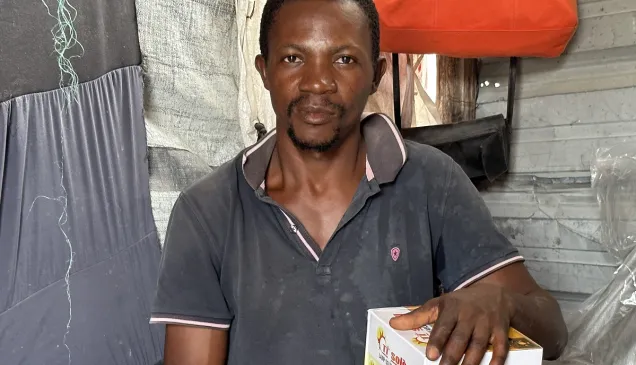 A man in Haiti with a solar lamp he received.