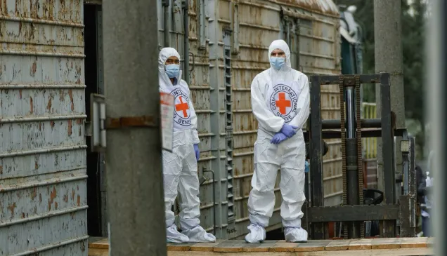 Two ICRC delegates in protective clothing