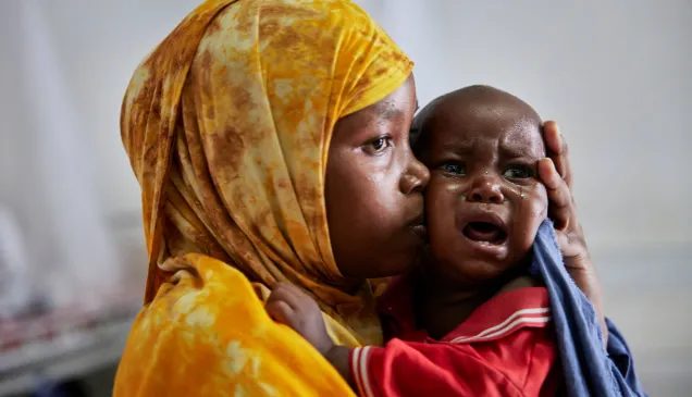 Marwo Abdikarim consoles her 11-month-old, Ahmed Hussein Mohamed, at the stabilization centre in Kismayo.