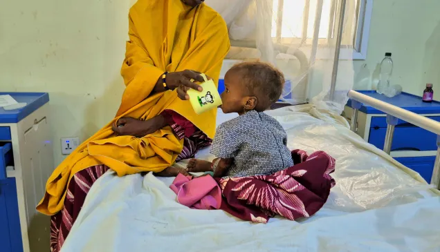 A malnourished child receives therapeutic milk during treatment at the stabilization centre in Damaturu.
