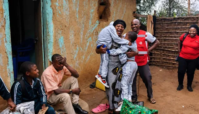 An overjoyed refugee mother in Kyaka II Refugee Settlement in Uganda reunited with her three children after 12 months of separation caused by conflict in the DRC. 