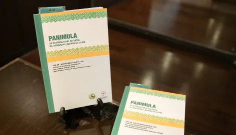 "IHL and Islamic law" book in Tagalog displayed on a desk