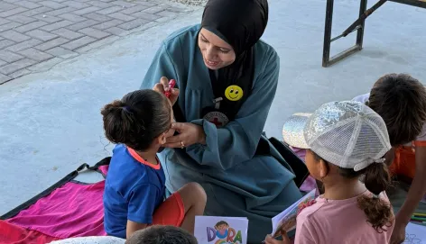 Dr Sally taking children through recreational activities to support mental health at the Gaza Field Hospital.jpg
