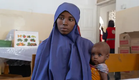 Nurta Ibrahim, 25, with her daughter, Salaada Mohamed at the Somali Red Crescent-run Howlwadaag outpatient therapeutic centre seeking treatment.