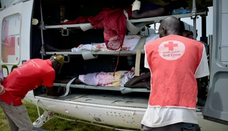 South Sudan Red Cross Society volunteers assisting patients before they are evacuated to Juba