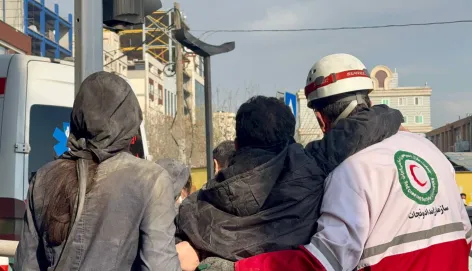 IRCS Rescue and Relief staff help an injured person in Tehran
