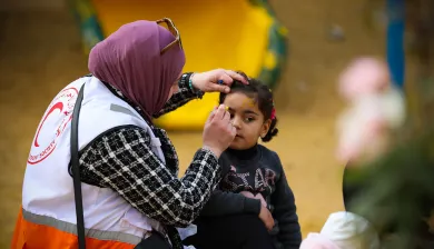 ICRC_Delegate helping a child