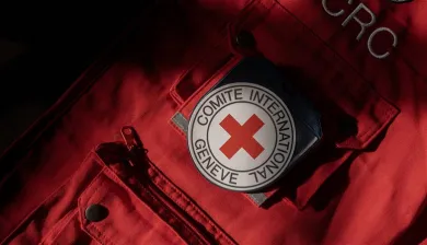 Close-up of red ICRC vest with ICRC emblem on the pocket