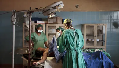 Surgeons in an operation theatre with a patient on the operating table