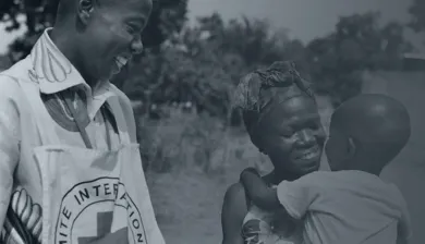 ICRC helps people in  conflict areas, woman helping some children 