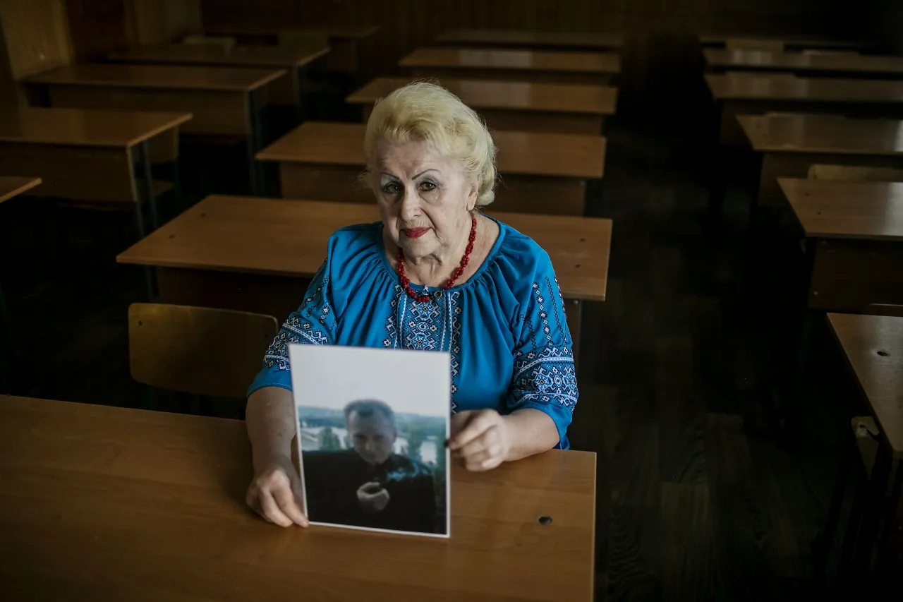 Lidiia holds one of Borys' photographs