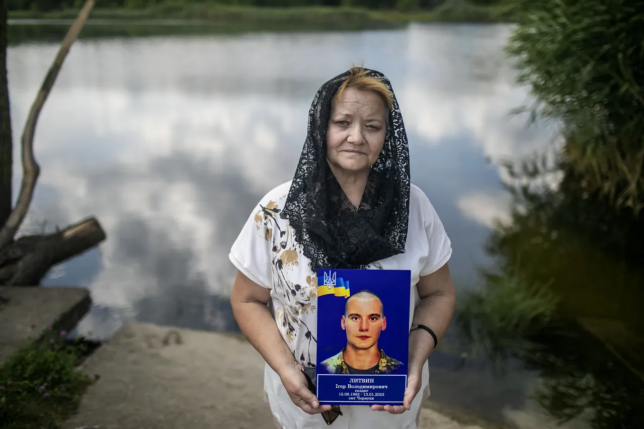 Valentyna Savustianenko holding a picture of her son, Ihor Lytvyn