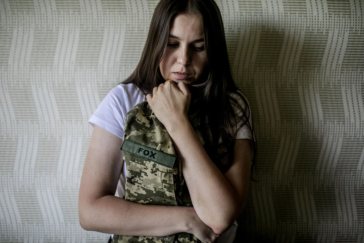 Svitlana Svitlana leaning against a wall in her home