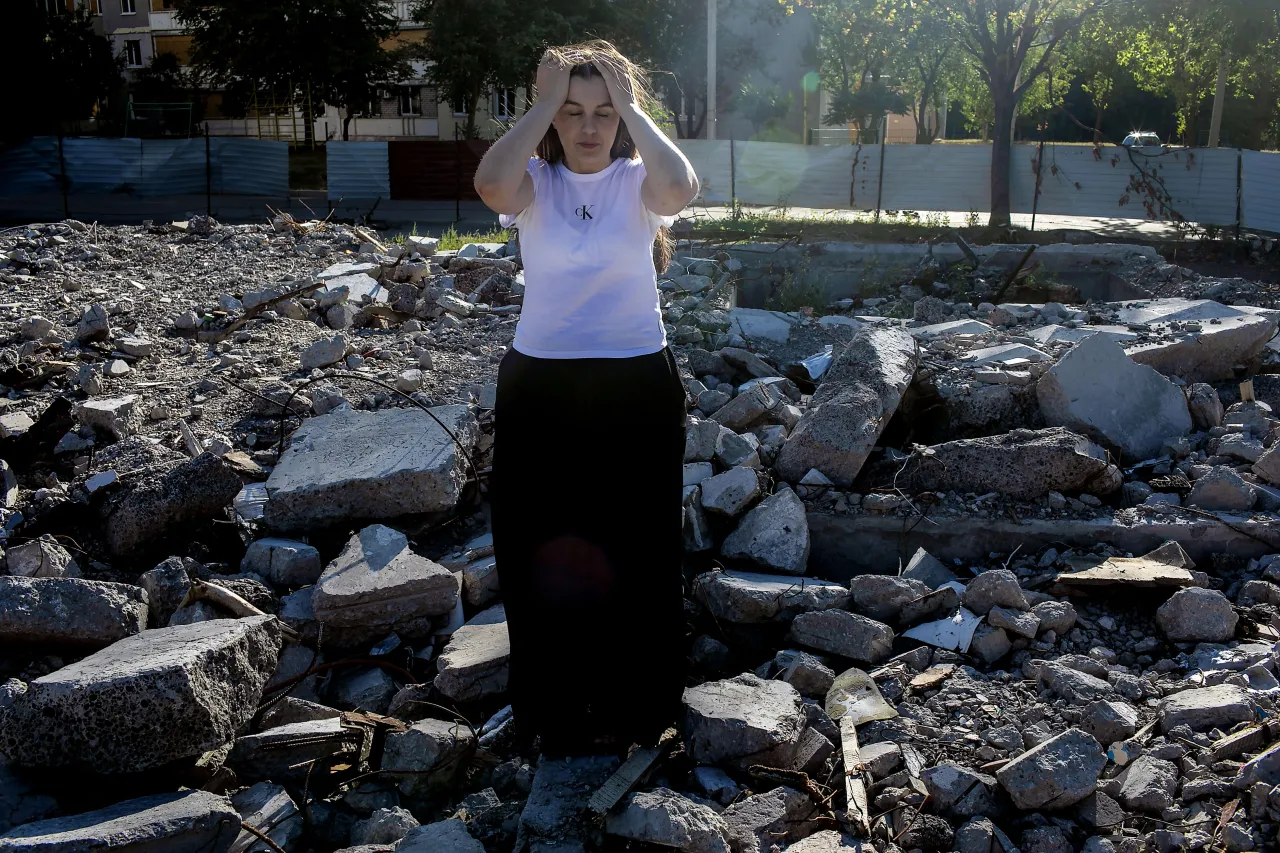 Svitlana is standing at the location of a building in Saltivka, Kharkiv, which has hit in 2022. At the time, Svitlana and Anatolii volunteered to help people trapped in their building.