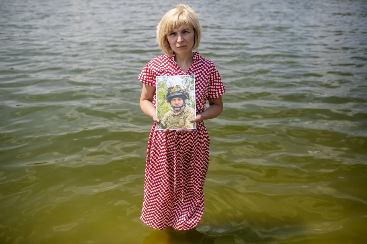 Nina standing by the waters of the Sviatoshynske Lake in Kyiv, reflects on the memories she and Vasyl shared here, a place where they spend time together. 