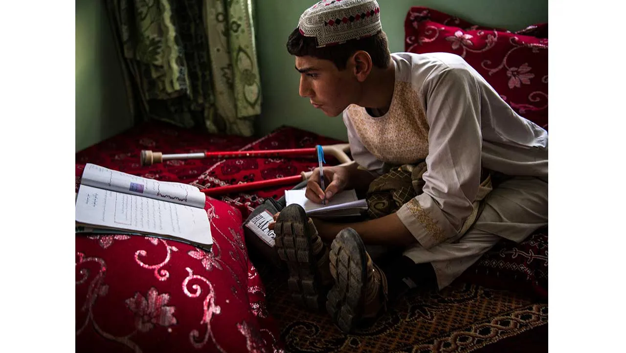 Shamsullah is 14 years old. He lost his legs in a landmine explosion in 2015