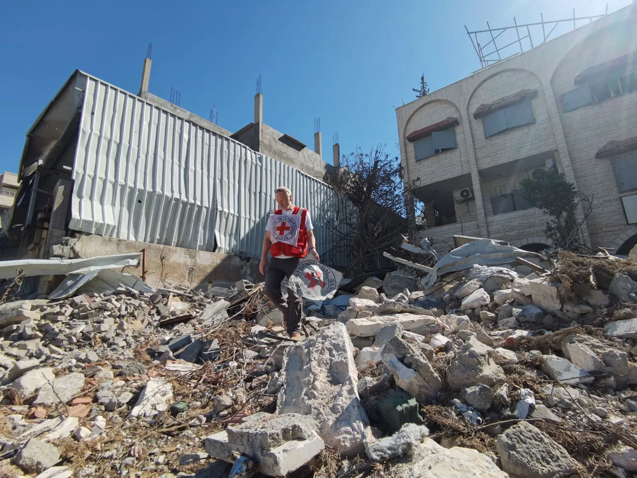 ICRC staff assessing a collapsed building