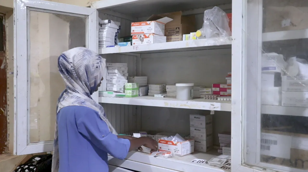 A nurse takes medicines from a cabinet at Atbara Teaching Hospital in River Nile state